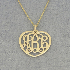 Small 10k or 14k solid gold heart monogram pendant with three custom initials on a gold chain.