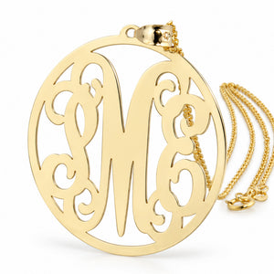 10K and 14K solid gold large circle monogram pendant necklace with ornate M E initials on a white background.