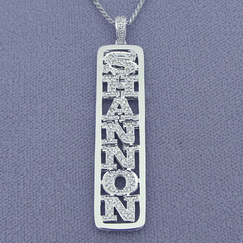 Close-up of genuine handset diamonds in solid gold vertical name pendant