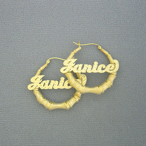 Pair of 10K/14K solid gold bamboo hoop earrings featuring personalized diamond-cut script name Janice