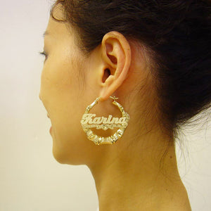 Model wearing 1.7-inch personalized gold bamboo name hoop earrings