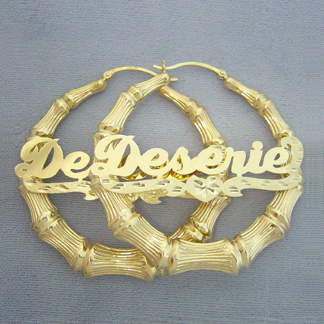 Custom 10k and 14k gold personalized name bamboo hoop earrings featuring cursive nameplate and diamond-cut heart accent.