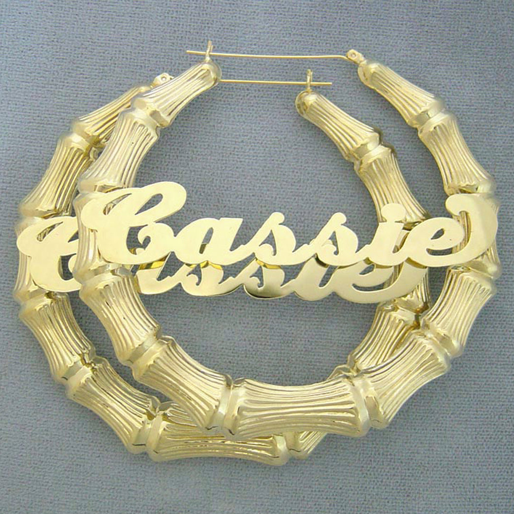 Custom 3-inch 10K gold bamboo hoop earrings featuring personalized cursive nameplate Cassie