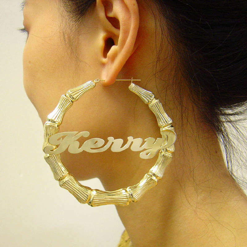 Close-up of custom cursive name lettering inside 10K real gold extra large bamboo hoop earring