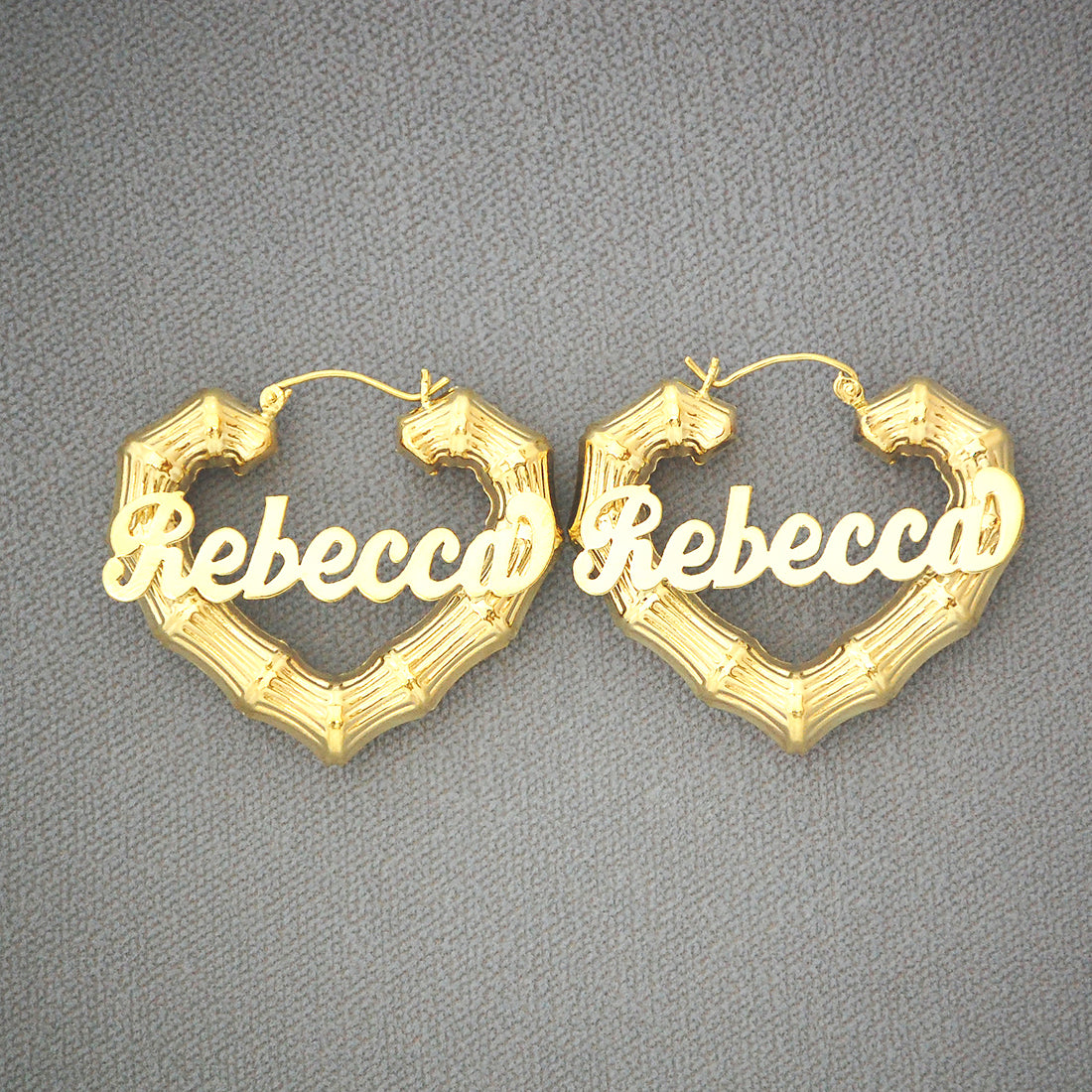 Custom cursive nameplate on 10k gold heart bamboo hoop earring close up
