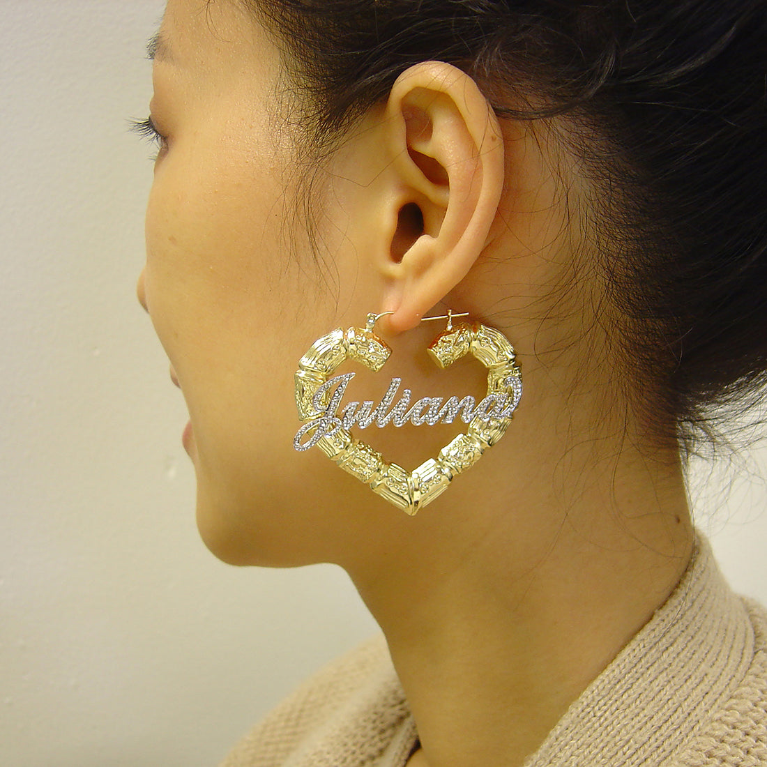 10K gold two-tone iced out heart bamboo name earrings (2.18 inch) worn on model