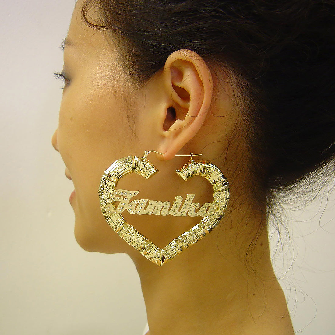Large 3-inch 10K gold personalized puffy heart bamboo hoop earrings worn on model