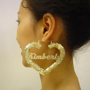 Model wearing 3.5 inch extra large 10k gold diamond name puffy heart bamboo hoop earrings