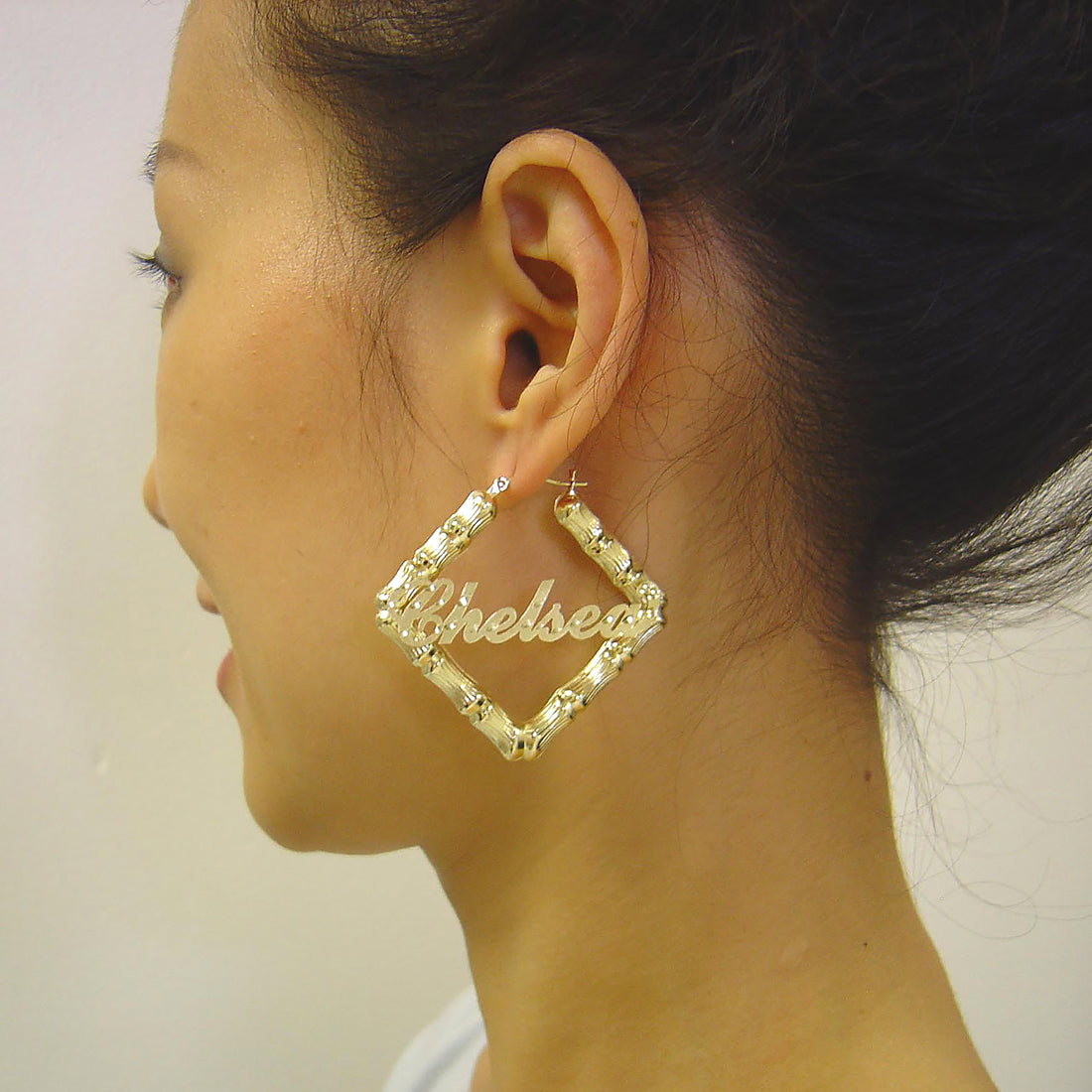 Close-up view of personalized 10k gold square bamboo hoop earring showing diamond-cut accent detailing