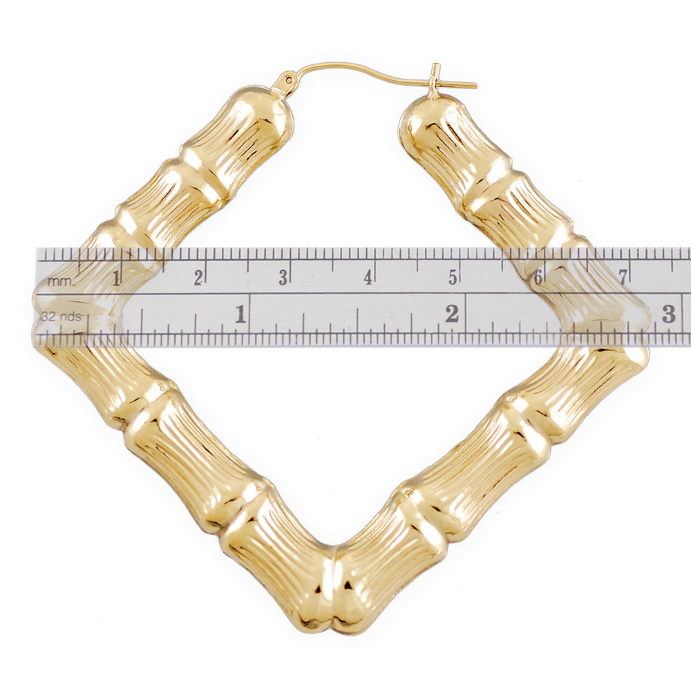 Detail of 10K gold puffed hollow bamboo hoop earring with secure snap closure