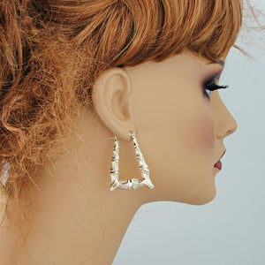 10K yellow gold rectangular bamboo hoop doorknocker earrings on mannequin.