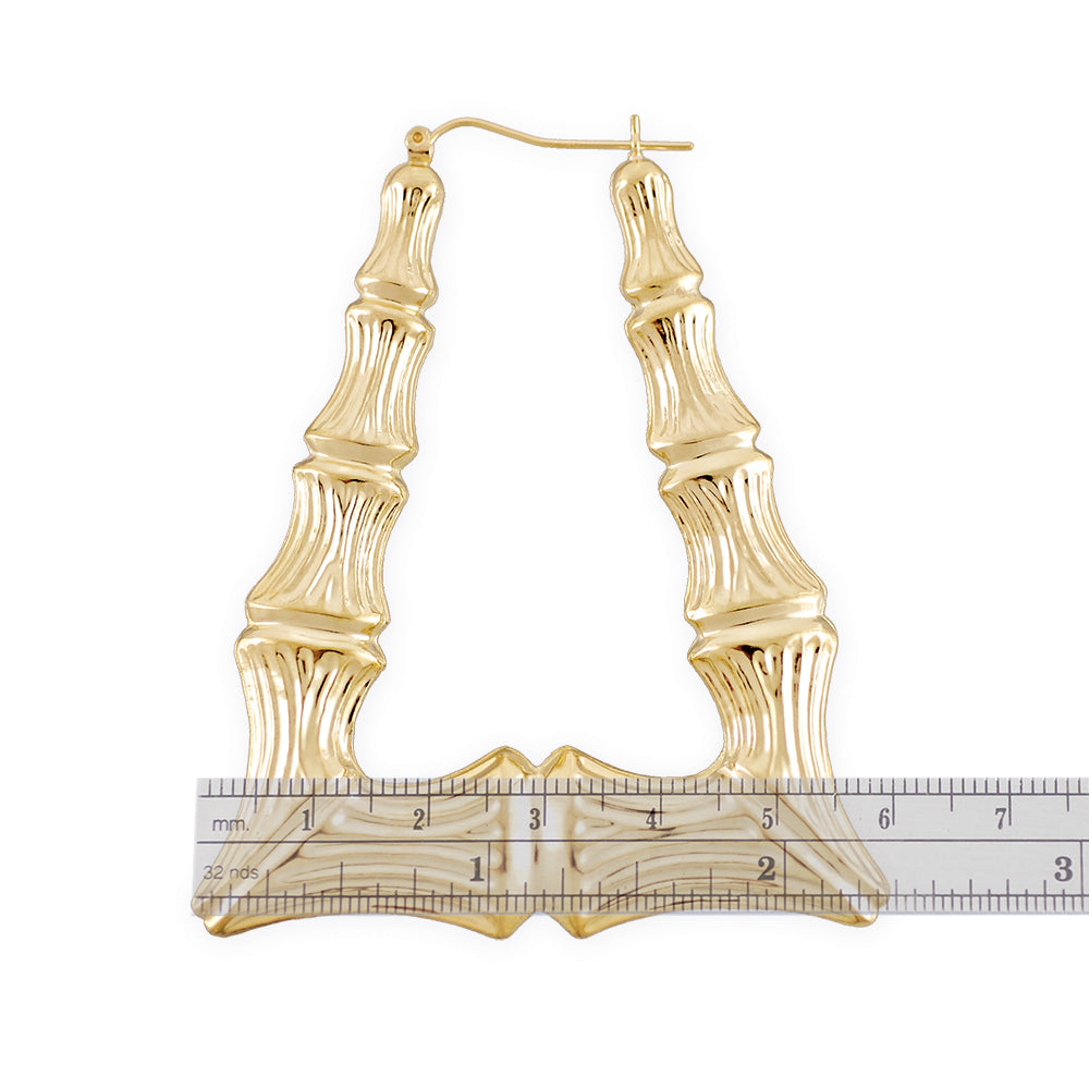 Close-up of puffed rectangular bamboo pattern and latch-back clip on 10K gold door knocker earring.