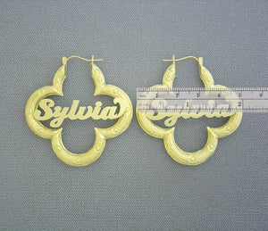 Detail view of custom cursive nameplate on 10K yellow gold flower bamboo hoop earring