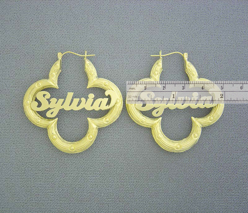 Detail view of custom cursive nameplate on 10K yellow gold flower bamboo hoop earring