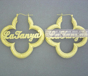 Close-up of personalized nameplate on 10K yellow gold flower bamboo hoop earring