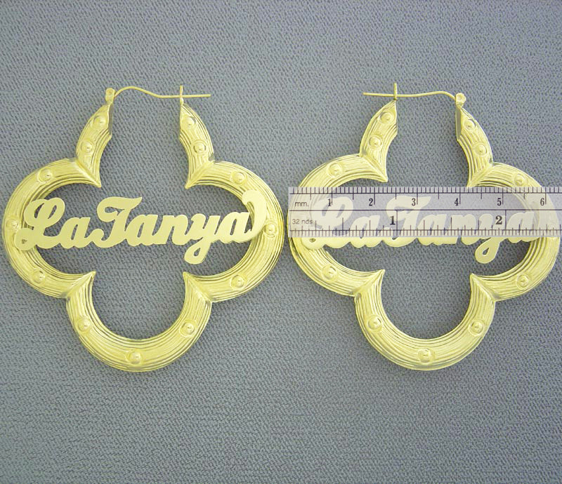 Close-up of personalized nameplate on 10K yellow gold flower bamboo hoop earring