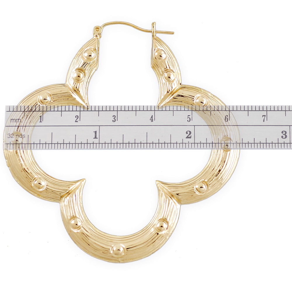 Detail view of 10K yellow gold flower bamboo hoop earrings.