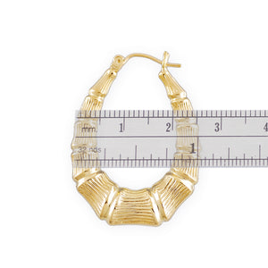 Close-up view of 10K gold bamboo hoop earring texture and clip closure