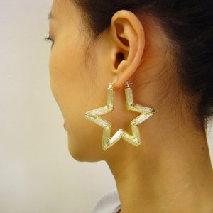 Model wearing 2.1 inch 10K gold star bamboo door knocker hoop earring