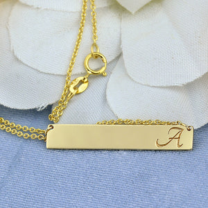Close-up of high-polish 10k solid white gold bar pendant with clear laser engraving