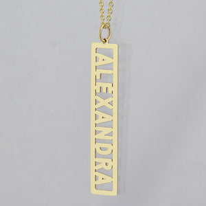 Custom 14k yellow gold vertical bar pendant necklace personalized with the name Alexandra