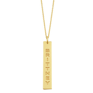 Close-up view of deep laser engraving on a 1.25 inch solid gold vertical bar pendant