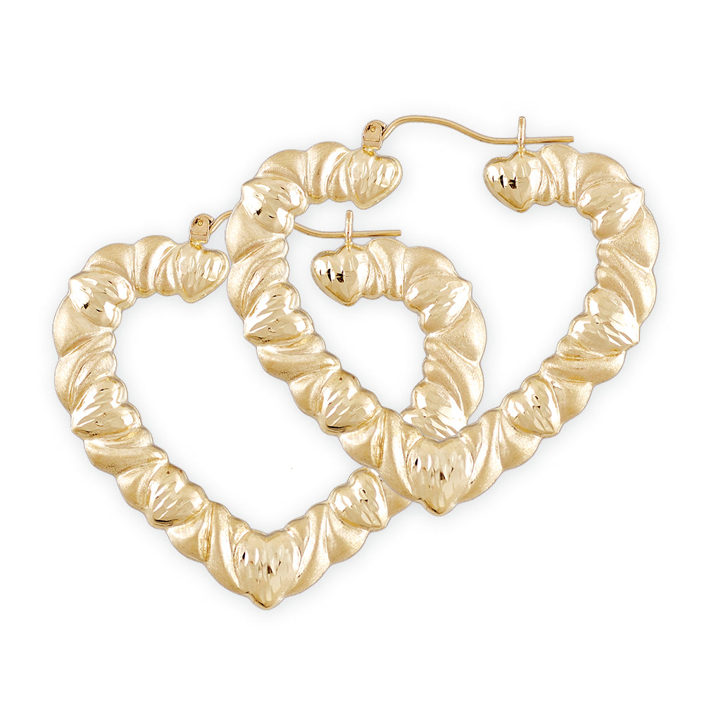 A pair of 10k gold hollow heart-shaped earrings with diamond cuts and a doorknocker design, approximately 1 7/8 inches in diameter.