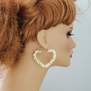 Mannequin wearing large 2.375 inch 10K yellow gold XO heart doorknocker hoop earrings
