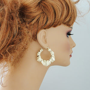 Mannequin wearing 1.9 inch 10K real gold XO puffy heart door knocker earrings