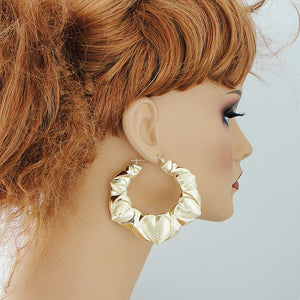 Extra large 2.75-inch 10K gold XO heart doorknocker earrings shown on mannequin.