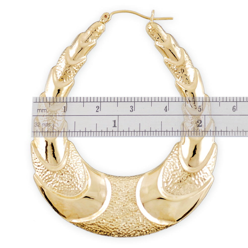 Side view of 10K gold ribbed oval shrimp door knocker hoop earring showing 7mm thickness