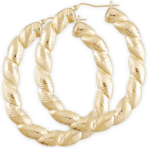 A pair of oval-shaped yellow gold twisted diamond cut earrings with a drop down design and a secure clip enclosure.