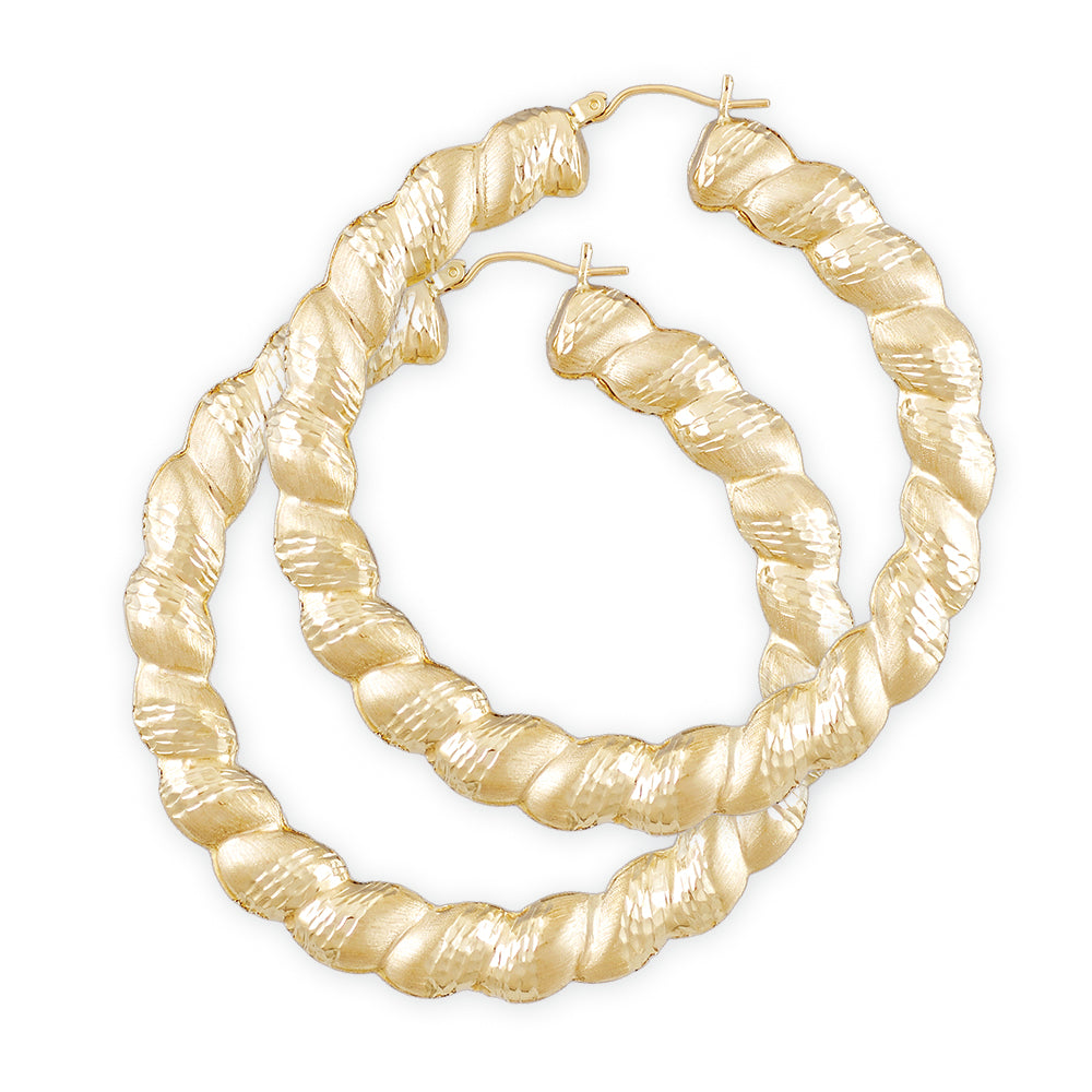 A pair of 10k yellow gold twisted round diamond cut hollow earrings with secure clip enclosures.