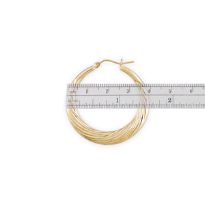 Close-up of 10K yellow gold swirl design and clip closure on door knocker hoop earrings