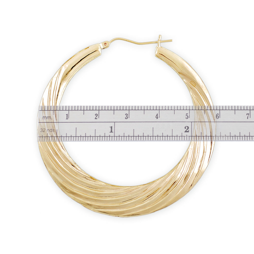 Close up of 10K yellow gold swirl pattern door knocker hoop earring hinge closure