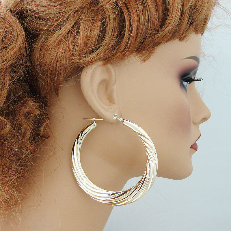 wearing 2.9 inch large 10K gold swirl door knocker earrings