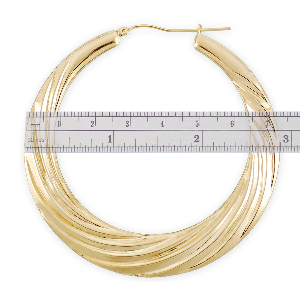 Close up of 10K gold door knocker hoop earrings with swirl texture
