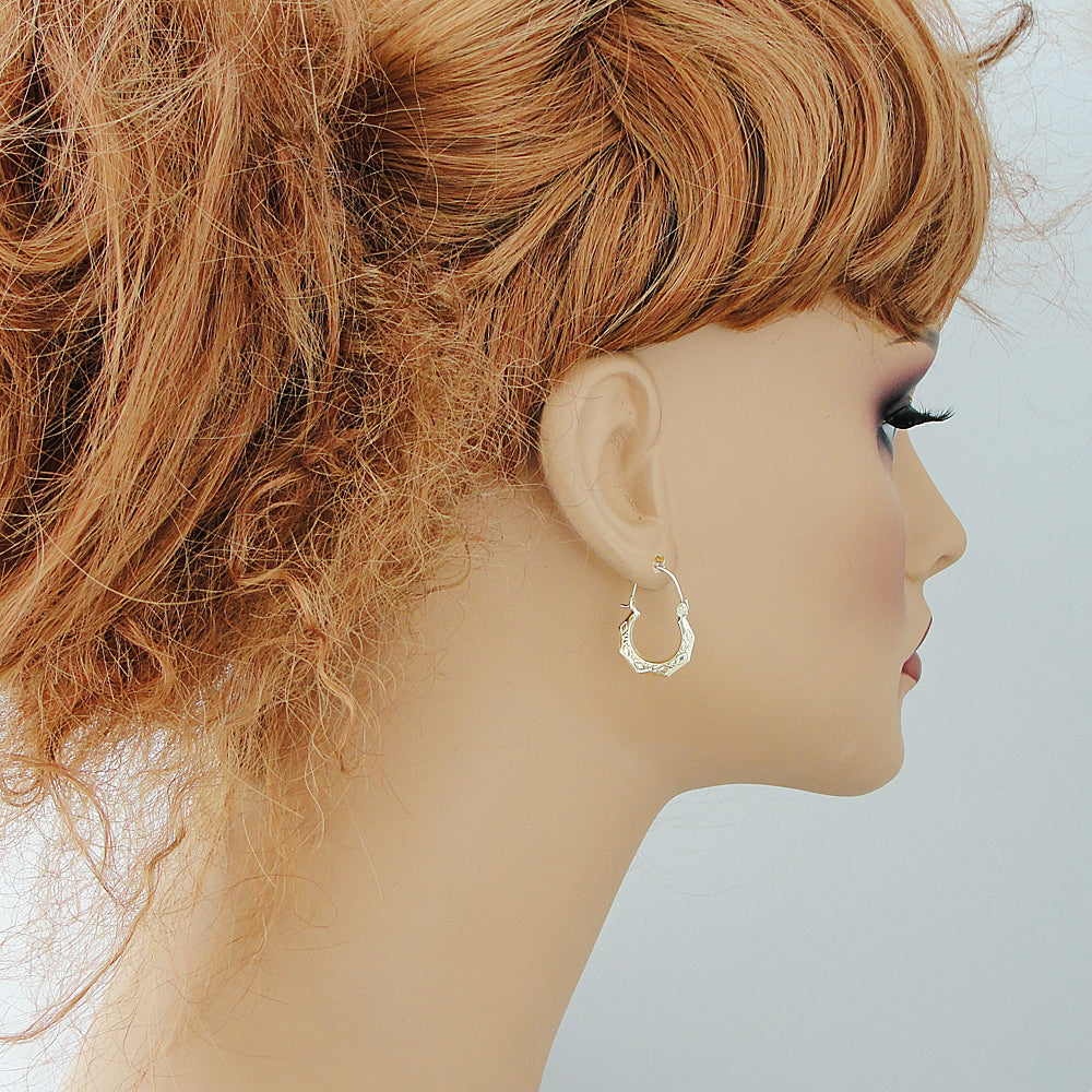 Baby wearing 10k yellow gold puffy doorknocker drop earrings showing size and fit