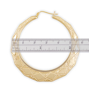 10k gold puffy door knocker hoop earring measured against a ruler showing 2.25 inch diameter