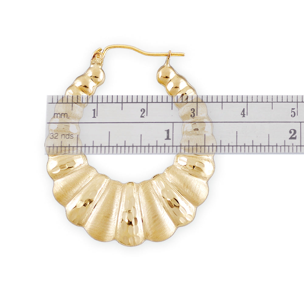 Close-up of diamond cut pattern and hinged snap closure on 10K gold shrimp door knocker earring