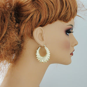 1.5 inch solid 10k gold diamond cut door knocker earrings on mannequin.