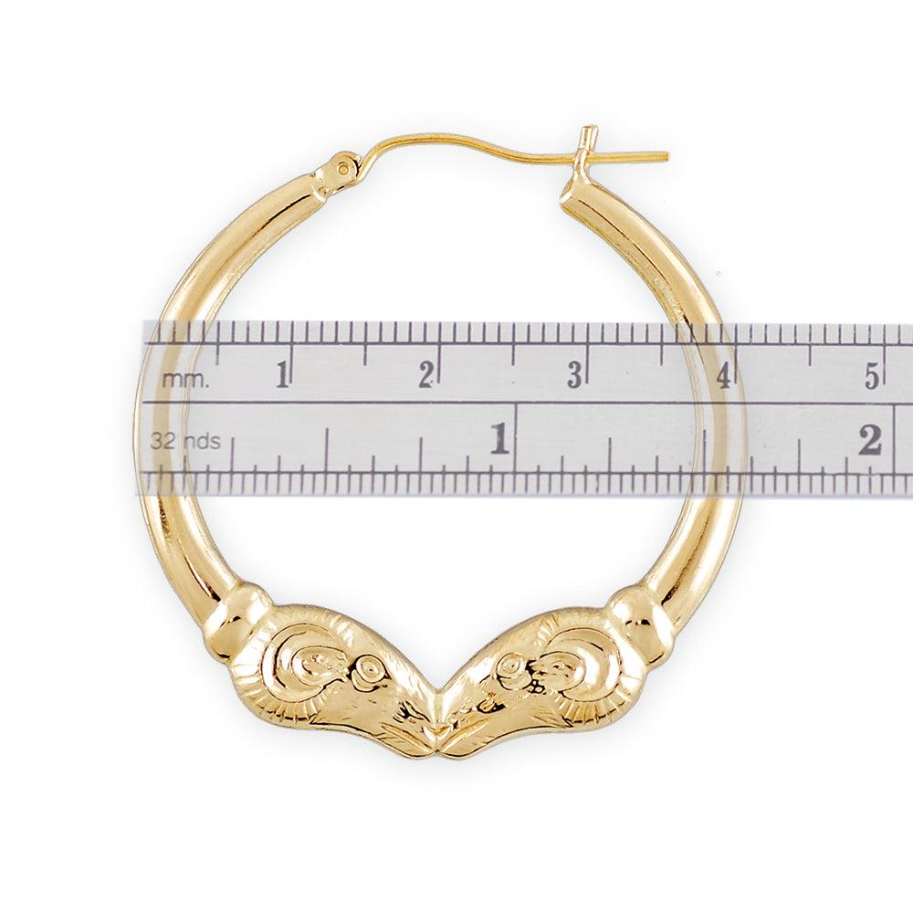 Close-up of high polish finish and intricate ram head detail on 10k solid gold hoop earrings