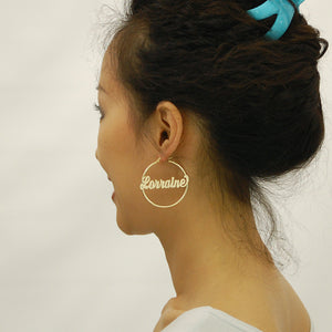 Side profile model wearing 1.75 inch 14K yellow gold custom name hoop earrings