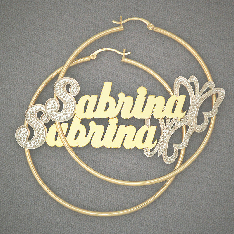 Detailed view of 14K two-tone iced-out cursive nameplate with butterfly accent