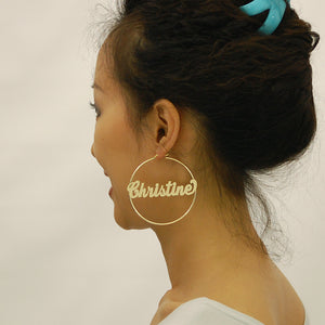 Model wearing 2.5 inch large 14K gold custom name hoop earrings