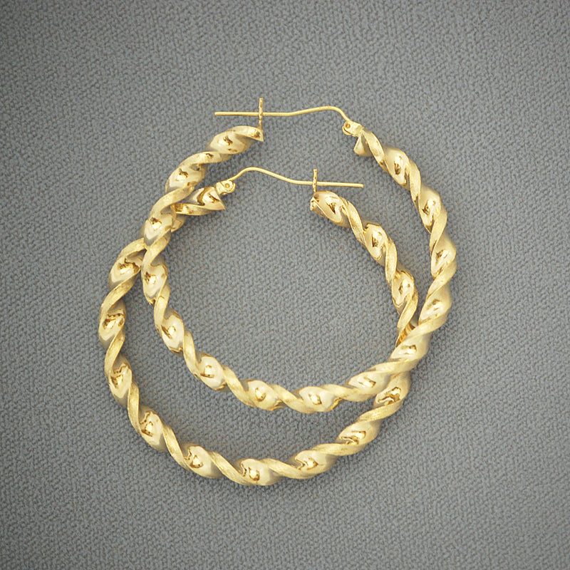 Pair of 10K yellow gold 4mm twisted hoop earrings with hinged snap closure on white background