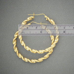 Close-up detail of 4mm hollow 10K gold twisted hoop earrings showing texture and clasp