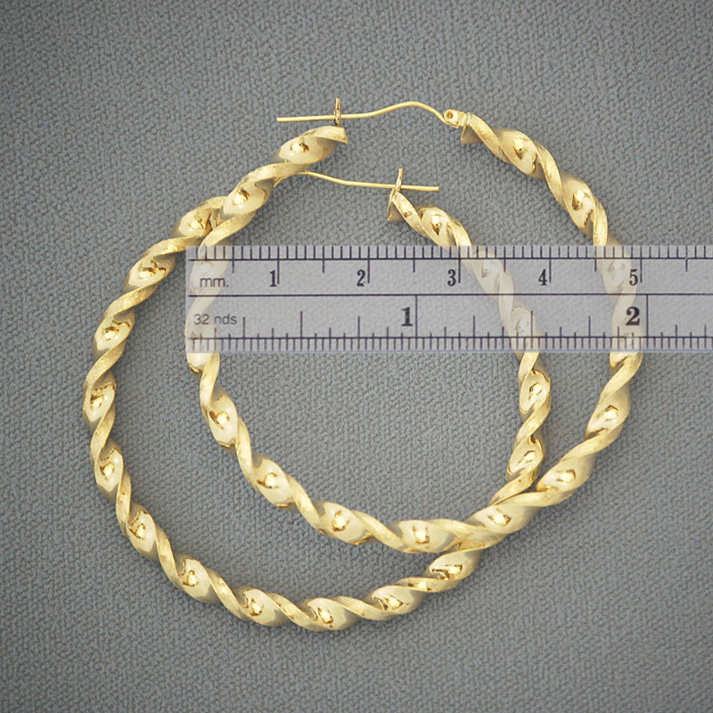 Close-up of 4mm twisted hollow design and snap closure on 10K gold hoop earring