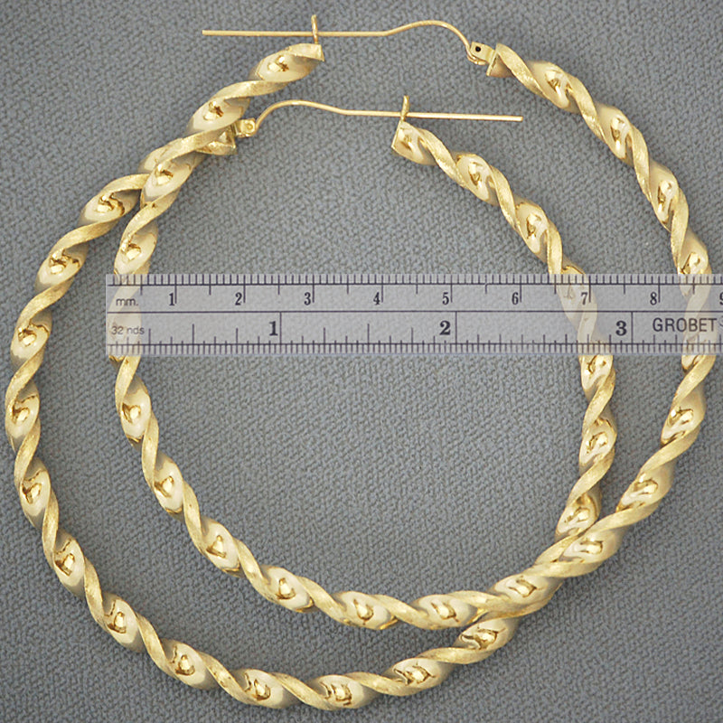 Close-up view of 4mm twisted design and secure hinged latch-back closure on 10k gold hoop earring