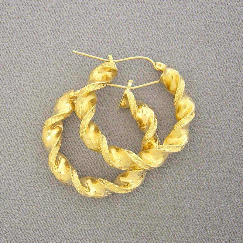 10K yellow gold 6mm twisted hoop earrings 40mm diameter on plain surface